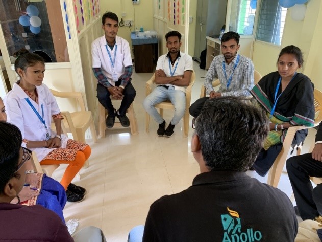 Group sitting in circle for staff briefing