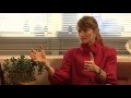 Jacqueline Novogratz - caucasian female sitting in chair with dark brown hair and red jacket