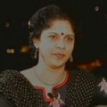 Ms. Sangeetha Chengappa - Headshot of Indian woman in black polka-dot dress wearing a necklace and earrings